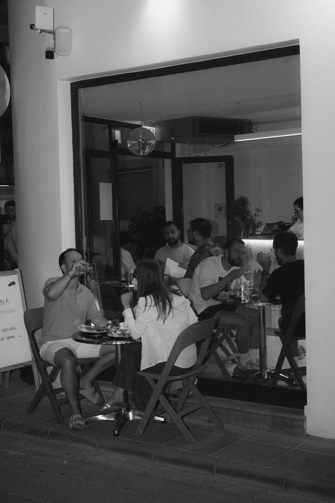 Guests sharing tables outside in the evening