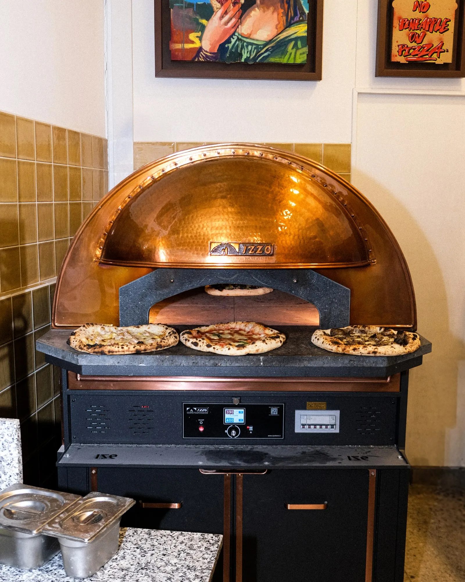 Three Neapolitan pizzas fresh out of the copper oven at Filomena in Larnaca