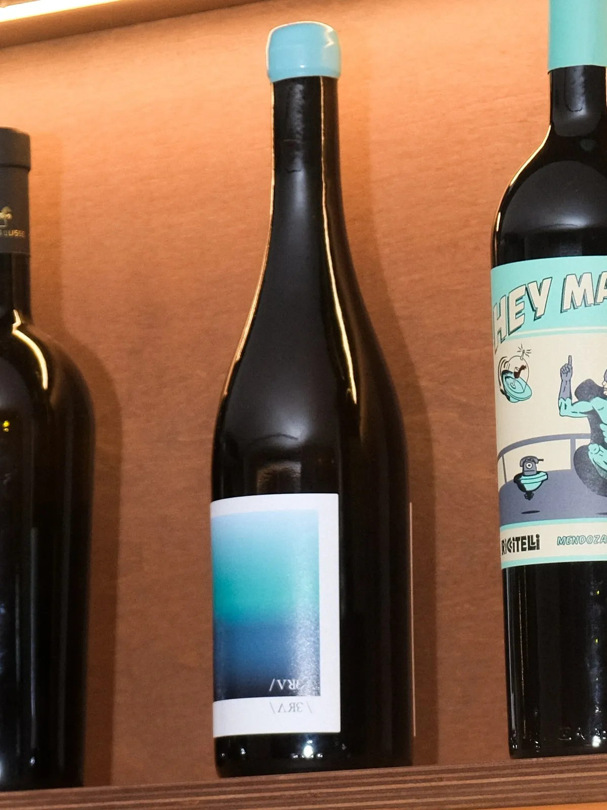 A bottle of Chatzivaritis Malagouzia on the lit shelf at Filomena in Larnaca